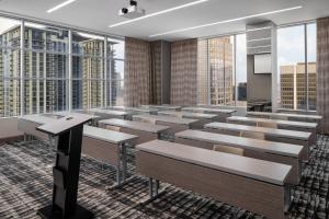 a lecture room with rows of benches and windows at AC Hotel by Marriott Orlando Downtown in Orlando