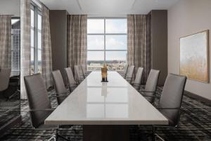 a conference room with a large white table and chairs at AC Hotel by Marriott Orlando Downtown in Orlando