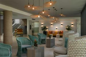 a living room with blue chairs and a couch at Renaissance Santo Domingo Jaragua Hotel & Casino in Santo Domingo