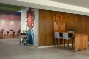 a room with a bar with a painting on the wall at Renaissance Santo Domingo Jaragua Hotel & Casino in Santo Domingo