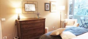 a bedroom with a dresser and a mirror on the wall at QuickHome - Le due Palme in Biella