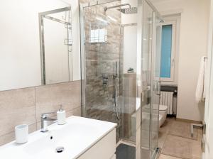 a bathroom with a shower and a sink and a toilet at QuickHome - Le due Palme in Biella +7 photos