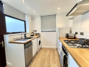 a kitchen with a sink and a stove top oven at Modernised 3-bed home in Bamber Bridge, Preston in Bamber Bridge