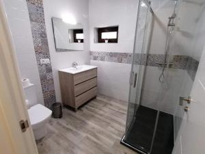 a bathroom with a shower and a sink and a toilet at Casa da Corna by Cristian&Tamara "alquileres" in Pobra do Caramiñal +13 photos
