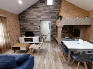 a living room with a blue couch and a table at Casa da Corna by Cristian&Tamara "alquileres" in Pobra do Caramiñal