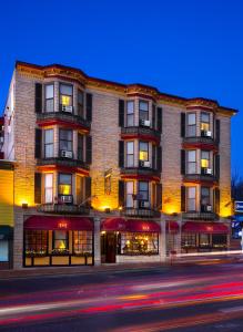 a large brick building on a city street at night at Inn at St John Portland In-Town in Portland