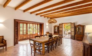 a dining room with a wooden table and chairs at Honor Vell - Hidden Valley Retreat in Bunyola