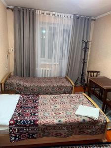 Postel nebo postele na pokoji v ubytování Baktygul guesthouse