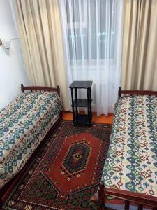 Postel nebo postele na pokoji v ubytování Baktygul guesthouse