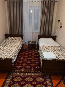 Postel nebo postele na pokoji v ubytování Baktygul guesthouse