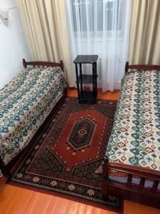 Postel nebo postele na pokoji v ubytování Baktygul guesthouse