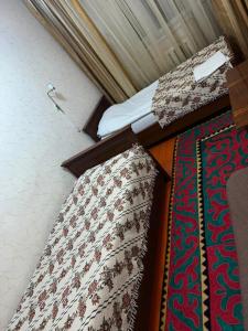 Postel nebo postele na pokoji v ubytování Baktygul guesthouse