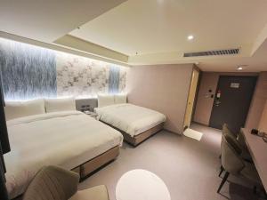 Rúm í herbergi á 新仕飯店-New City Hotel
