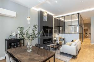 a living room with a dining table and a couch at Designer apartment 2 in Madrid