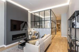 a living room with a couch and a tv at Designer apartment 2 in Madrid