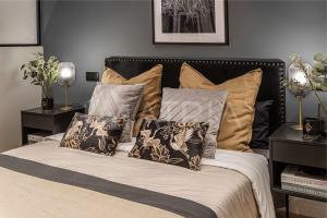 a bed with a bunch of pillows on it at Designer apartment 2 in Madrid