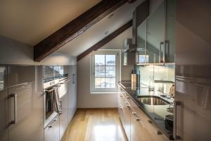 a large kitchen with a sink and a window at Lake Side Location Bellevue in Zürich