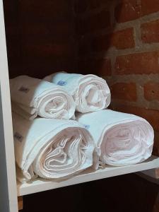 a shelf filled with lots of folded towels at Cabañas Franca Austral in Santa Rosa de Calamuchita +19 photos