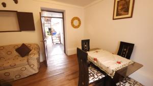 a living room with a table and a chair at Antuquita's House in Cusco