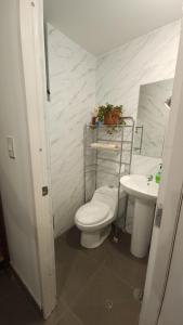 a bathroom with a toilet and a sink at Antuquita's House in Cusco +33 photos