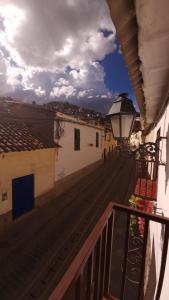 a balcony with a view of a street with buildings at Antuquita's House in Cusco