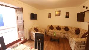 a living room with a couch and a table at Antuquita's House in Cusco