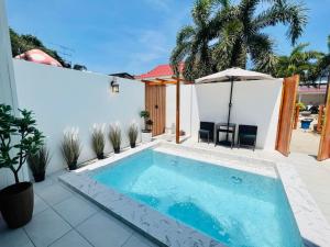 a swimming pool in the backyard of a house at Kaija Resort in Ko Larn