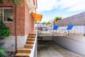 a balcony of a house with blue chairs on it at Villa Pla de l Era in Salou