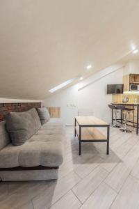 a living room with a couch and a table at CityApartments Kyiv Maidan in Kyiv