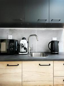 a kitchen counter with a sink and a microwave at Apartment Premium Jacuzzi, Old Town Cracow in Kraków