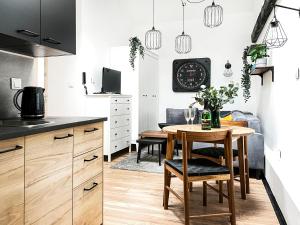 a kitchen with a table and a dining room at Apartment Premium Jacuzzi, Old Town Cracow in Kraków