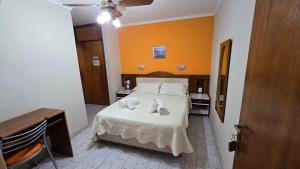a bedroom with a bed with two towels on it at Hotel San Martin in Villa María