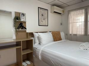 Postel nebo postele na pokoji v ubytování Cosy Lodge MRT Phra Ram 9