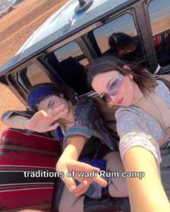 two women sitting in the back of a car at Traditions of Wadi Rum camp & jeep tour in Wadi Rum