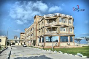 a large brick building on the side of a street at La mer Hotel in Alexandria