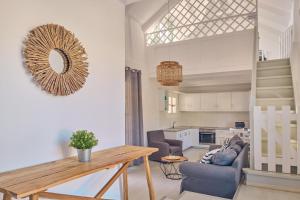 a living room with a table and a kitchen at Villa Cleo Periyali in Vasilikos +17 photos