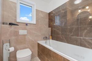 Un baño con bañera, inodoro y lavabo. en AH Galvaniho Free Parking, en Bratislava 12 fotos más