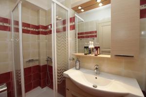 a bathroom with a sink and a shower at Avgerinos Hotel in Kambos