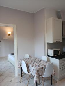 a kitchen with a table and chairs and a microwave at Giardino delle Ortensie in Cannobio