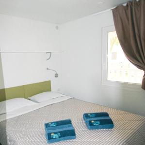 Postel nebo postele na pokoji v ubytování Happy Camp Mobile Homes in Torre Rinalda