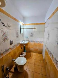 a bathroom with a toilet and a sink at 2BHK Modern Apartment in Colva +2 photos