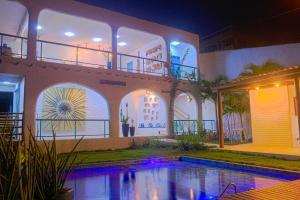 a house with a swimming pool at night at Casa Edom - Maceió in Maceió +22 photos