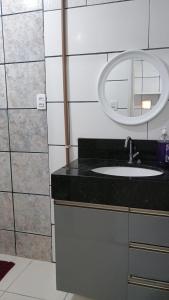 a bathroom with a sink and a mirror at Casa Espaçosa a 200m da praia in Florianópolis +58 photos