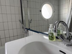 a bathroom with a sink and a mirror at ღ Le Gouverneur, Proche du port, Parking & Jardin in Saint-Martin-de-Ré +21 photos
