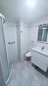 a white bathroom with a sink and a shower at Vv La Marina in Santa Cruz de la Palma +7 photos