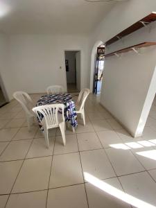 a dining room with a table and chairs at Casa do Bosque in Camaçari