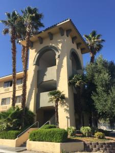 a large house with a large clock on the front of it at Ramada by Wyndham Barstow in Barstow