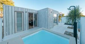 a modular house with a swimming pool on a deck at Villa Gioia Beach Front in Drage