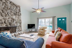 a living room with a couch and a stone wall at Teal Haven in Ocean Pines