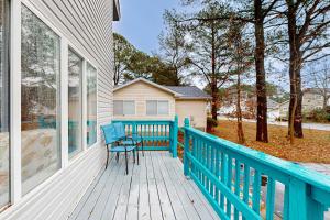 a blue bench sitting on the porch of a house at Teal Haven in Ocean Pines